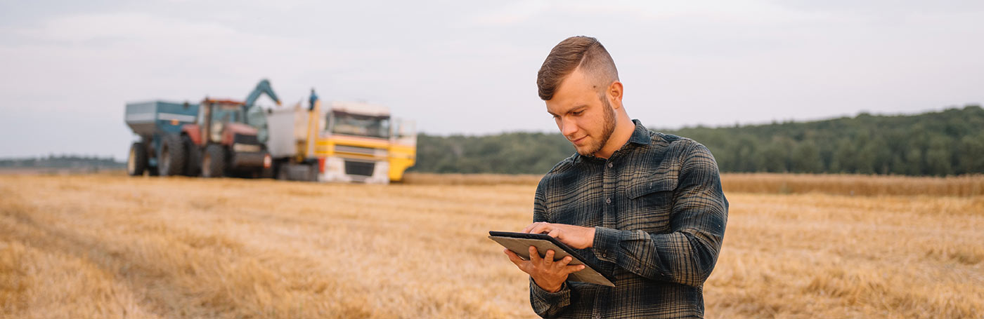 A man in checkered long sleeve with his tablet | Careers Collectiv