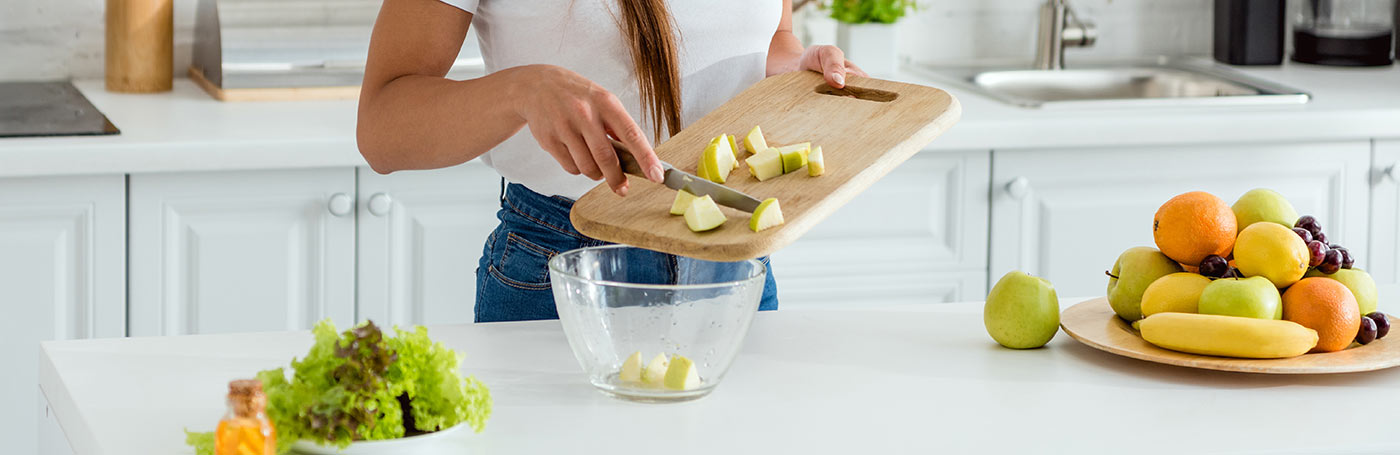 A woman in a half body seen is slicing fruits | Careers Collectiv