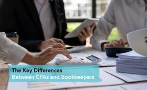 Differences Between CPAs and Bookkeepers - Bookkeepers in a meeting while computing with a calculator | Careers Collectiv