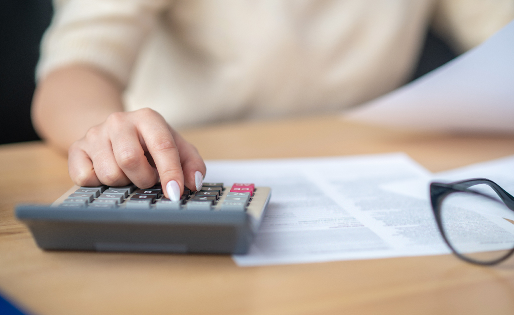 What are The Responsibilities of a Bookkeeper - A woman's hand typing on a calculator | Careers Collectiv